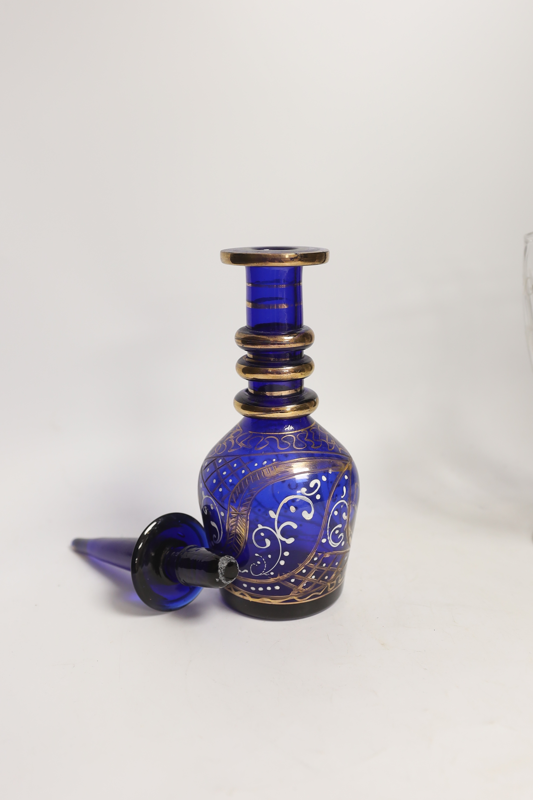 A Persian market blue glass decanter and an etched glass celery vase, tallest 34cm